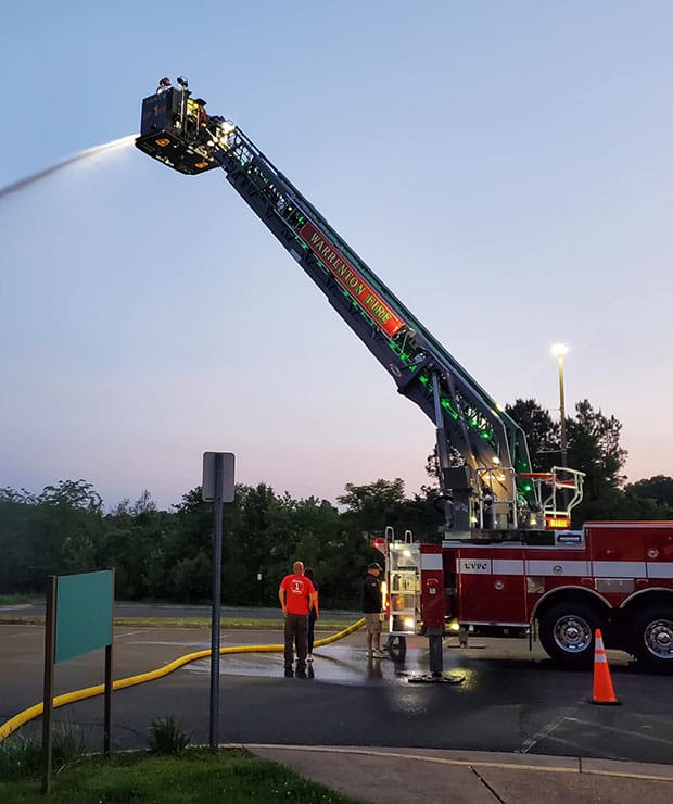 Tower firetruck with bucket extended spraying water - Warrenton Volunteer Fire Company