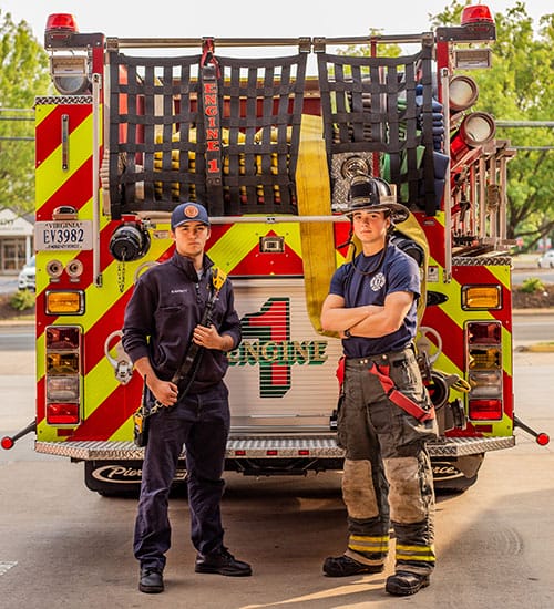 Warrenton Volunteer Fire Company Mission - image of confident firefighters holding tools in front of truck